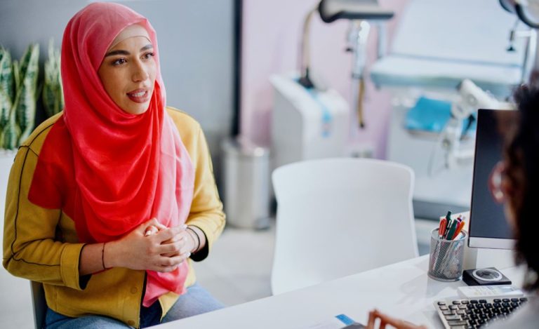 A Muslim patient reviews the results of medical tests with her female gynecologist